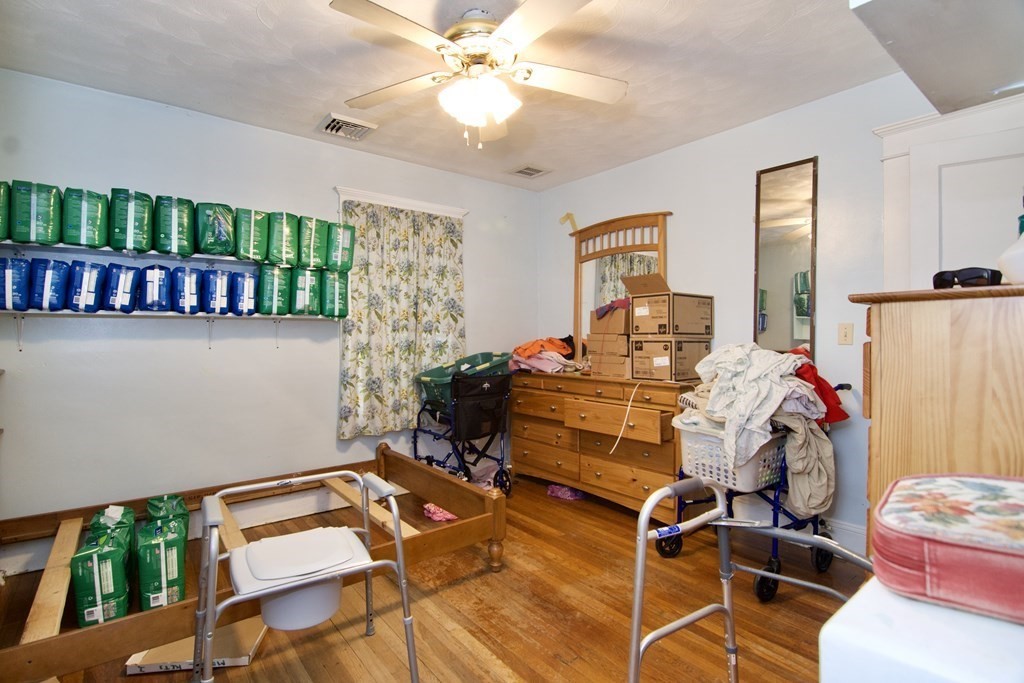 57 Bevier Street Springfield, MA 01107 - Photo 18 of 22 a bedroom with a bed and a chandelier