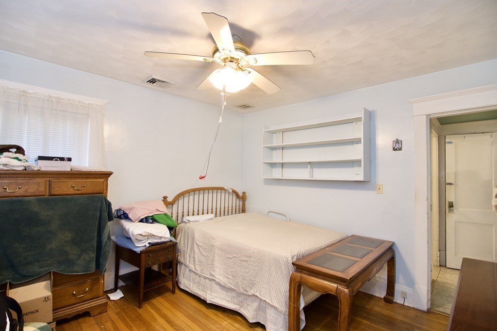 57 Bevier Street Springfield, MA 01107 - Photo 19 of 22 a bedroom with a bed and a chandelier