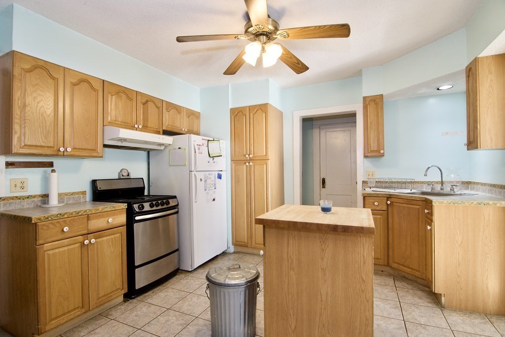 57 Bevier Street Springfield, MA 01107 - Photo 4 of 22 a kitchen with stainless steel appliances granite countertop a sink stove and refrigerator