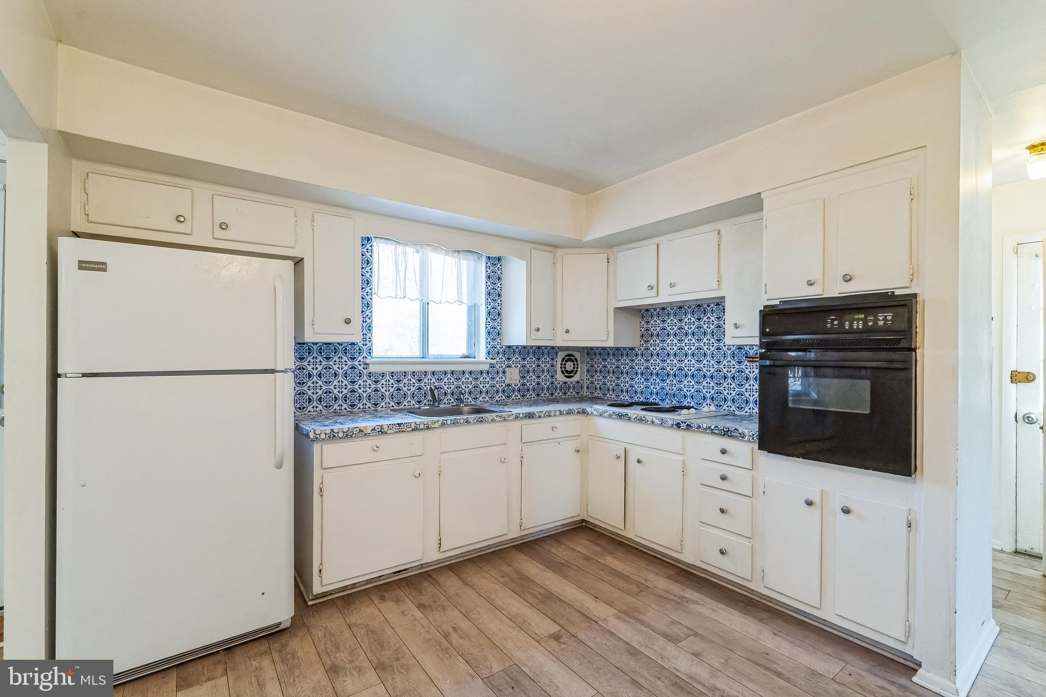 315 Shaw Road Ridley Park, PA 19078 - Photo 12 of 50 a kitchen with stainless steel appliances granite countertop a refrigerator sink and white cabinets