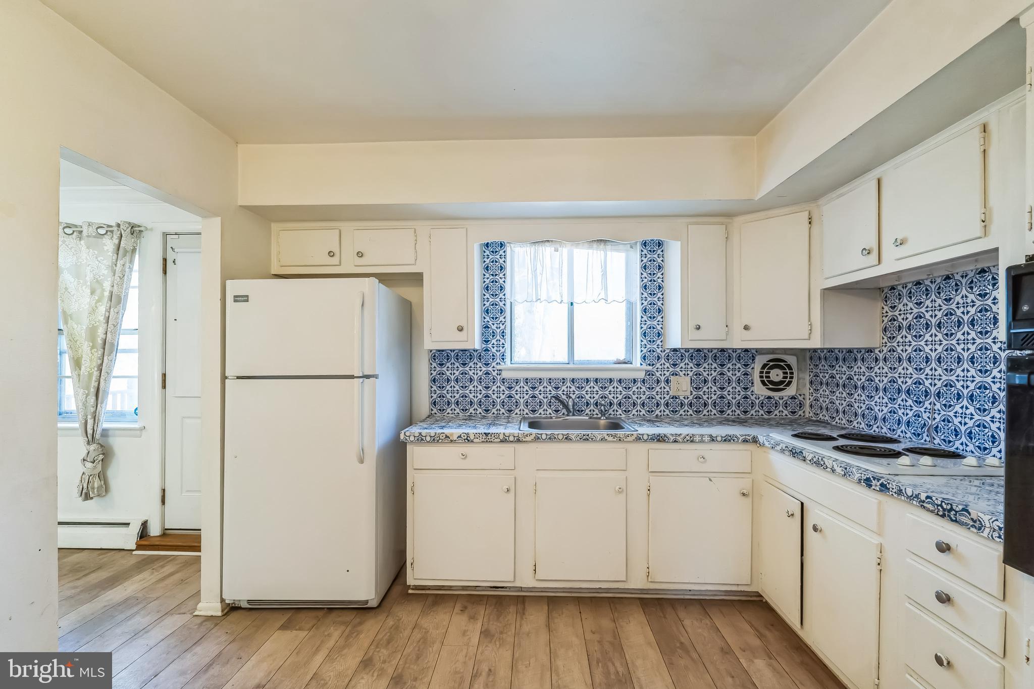 315 Shaw Road Ridley Park, PA 19078 - Photo 13 of 50 a kitchen with a refrigerator a sink and cabinets