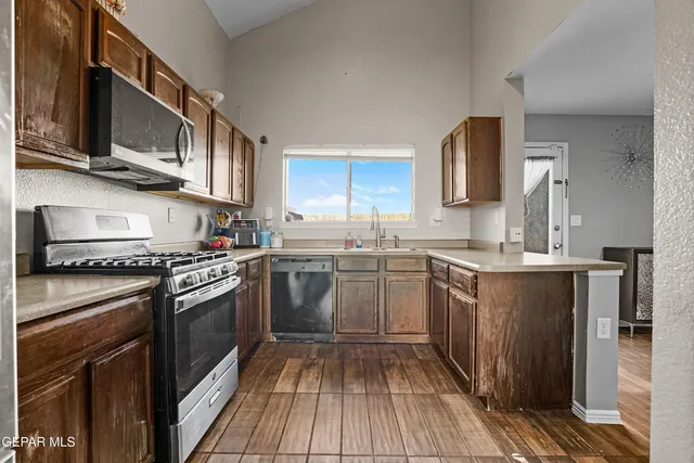 a kitchen with a stove top oven sink and cabinets