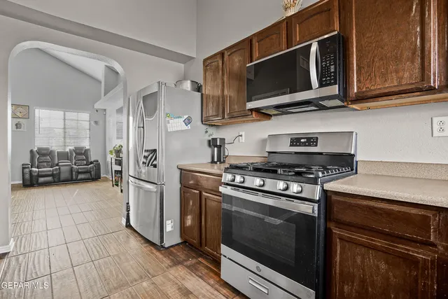a kitchen with stainless steel appliances a stove a microwave and cabinets