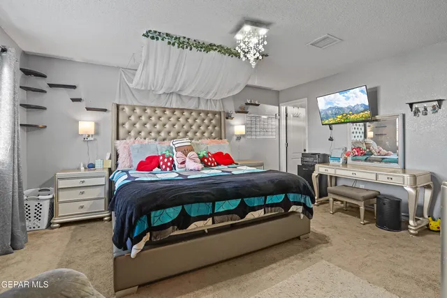 a bedroom with furniture and a baby crib