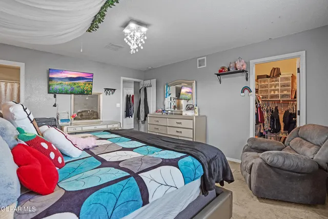 a bedroom with a bed and a chandelier