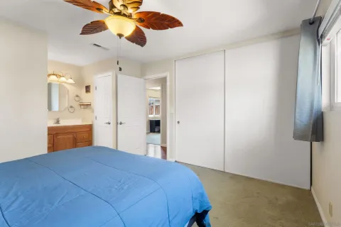 a bedroom with a bed and a painting on the wall