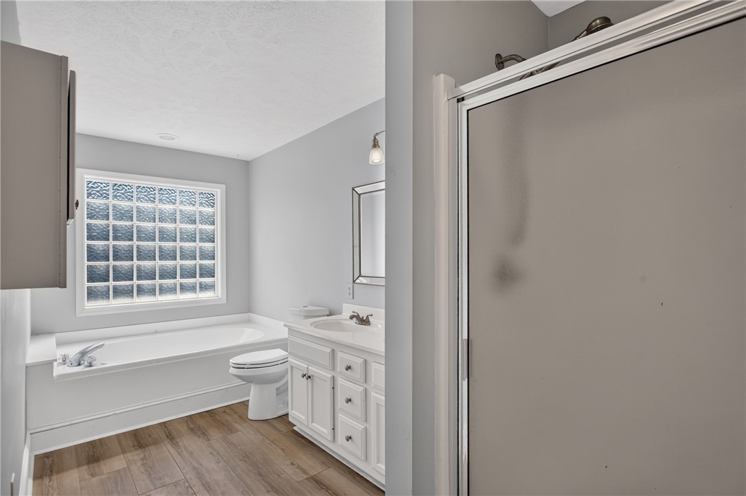 612 Providence Point Drive Seneca, SC 29678 - Photo 12 of 43 A well-lit bathroom provides a comfortable soaking tub next to a glass block window for privacy.