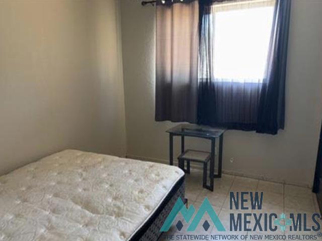 2415 Northwest Oro Road Albuquerque, NM 87107 - Photo 4 of 9 Room featuring light-toned wall paint and tiled flooring