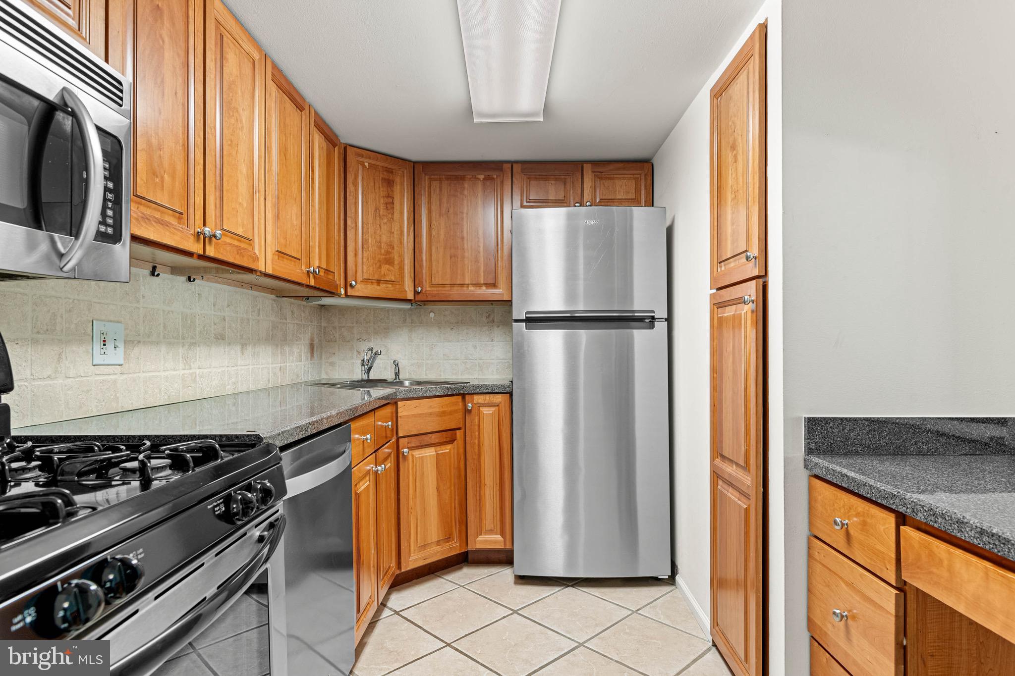 423 Old Forge Crossing, Unit 423 Devon, PA 19333 - Photo 10 of 24 Kitchen w/ Stainless Steel Appliances