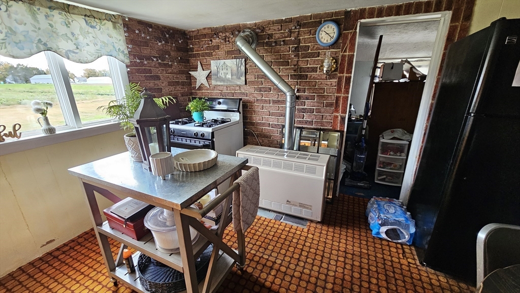 71 Russell Street Hadley, MA 01035 - Photo 9 of 32 a view of a workspace with furniture and a window