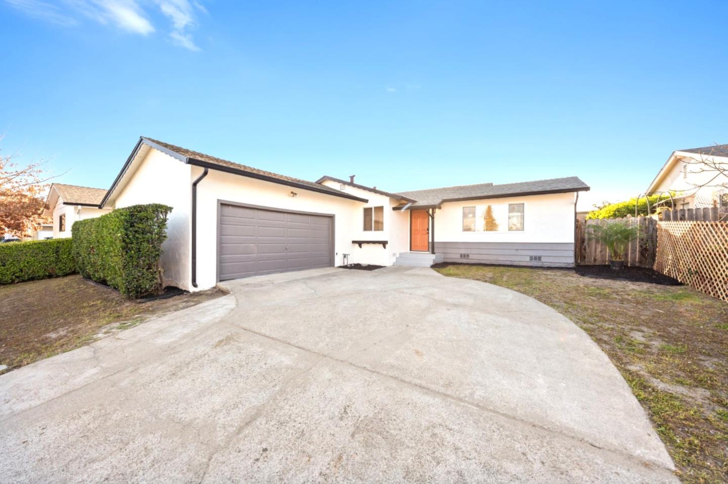 a view of a house with a backyard and a garage