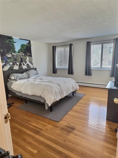 1039 Commonwealth Avenue, Unit 36 Boston, MA 02215 - Photo 1 of 6 a spacious bedroom with a bed and wooden floor
