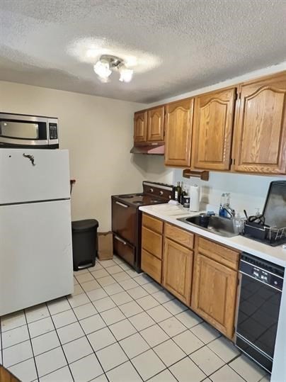 1039 Commonwealth Avenue, Unit 36 Boston, MA 02215 - Photo 3 of 6 a kitchen with a sink a stove and cabinets