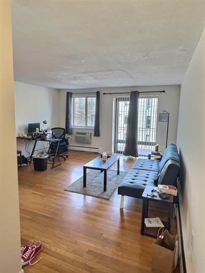 1039 Commonwealth Avenue, Unit 36 Boston, MA 02215 - Photo 4 of 6 a living room with furniture and a large window