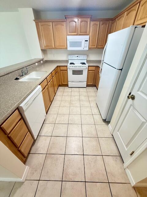 a kitchen with granite countertop a stove a sink and a microwave