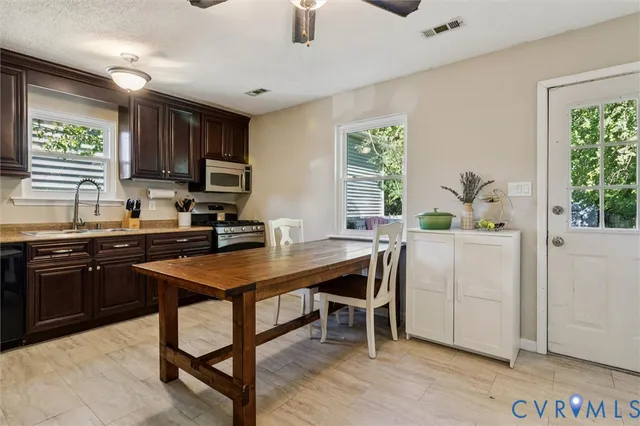 a kitchen with a table chairs sink and cabinets