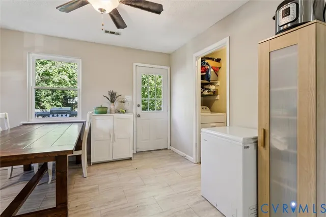 a view of a workspace with furniture and window
