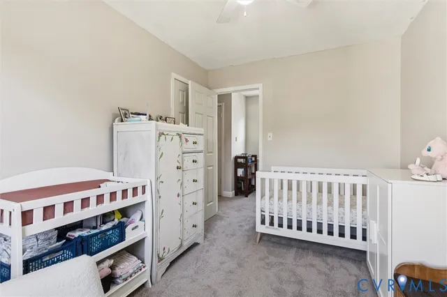 a bedroom with furniture and baby crib