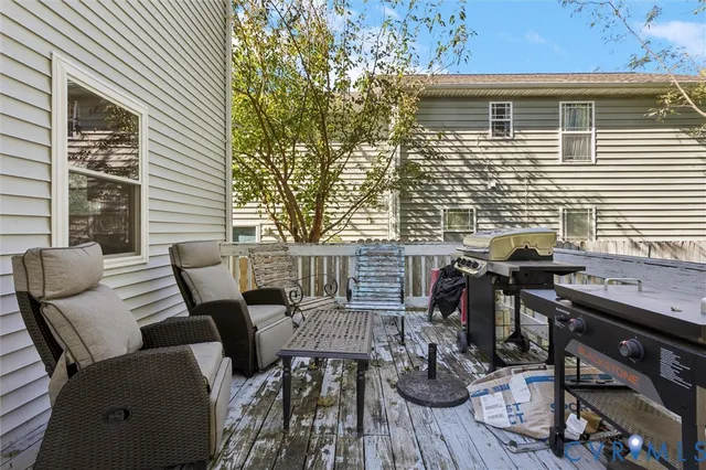 a view of a deck with table and chairs and wooden floor