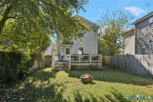 a view of a backyard with table and chairs and wooden fence