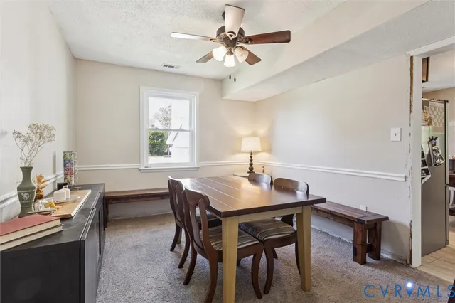 a dining room with furniture and window