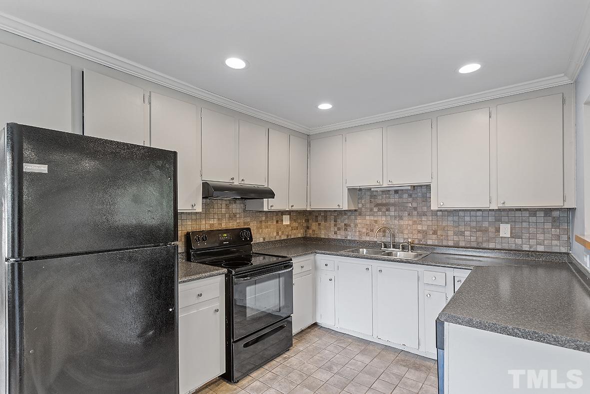 2727 Layden Street Raleigh, NC 27603 - Photo 13 of 23 a kitchen with a refrigerator sink and cabinets