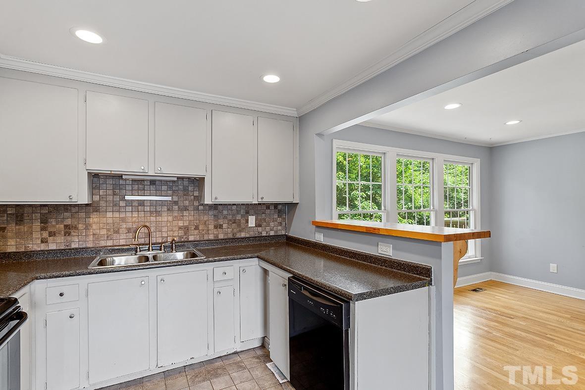 2727 Layden Street Raleigh, NC 27603 - Photo 14 of 23 a kitchen with a sink stove and cabinets
