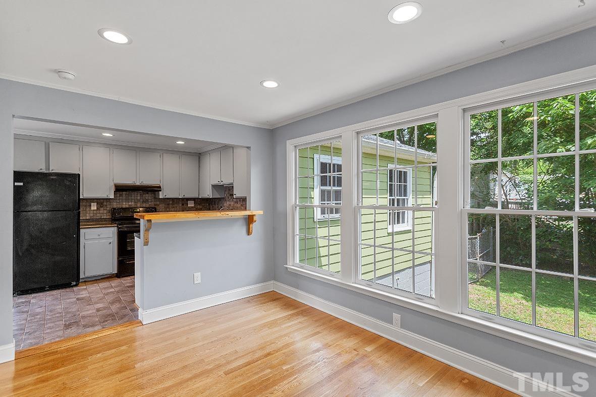 2727 Layden Street Raleigh, NC 27603 - Photo 17 of 23 a kitchen with stainless steel appliances granite countertop a refrigerator a sink a stove and a wooden floors