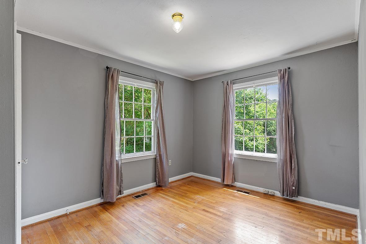 2727 Layden Street Raleigh, NC 27603 - Photo 21 of 23 a view of an empty room with wooden floor and a window