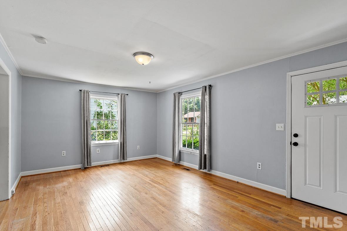 2727 Layden Street Raleigh, NC 27603 - Photo 9 of 23 a view of an empty room with a window and wooden floor