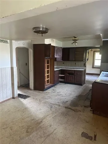 a living room with furniture and a kitchen