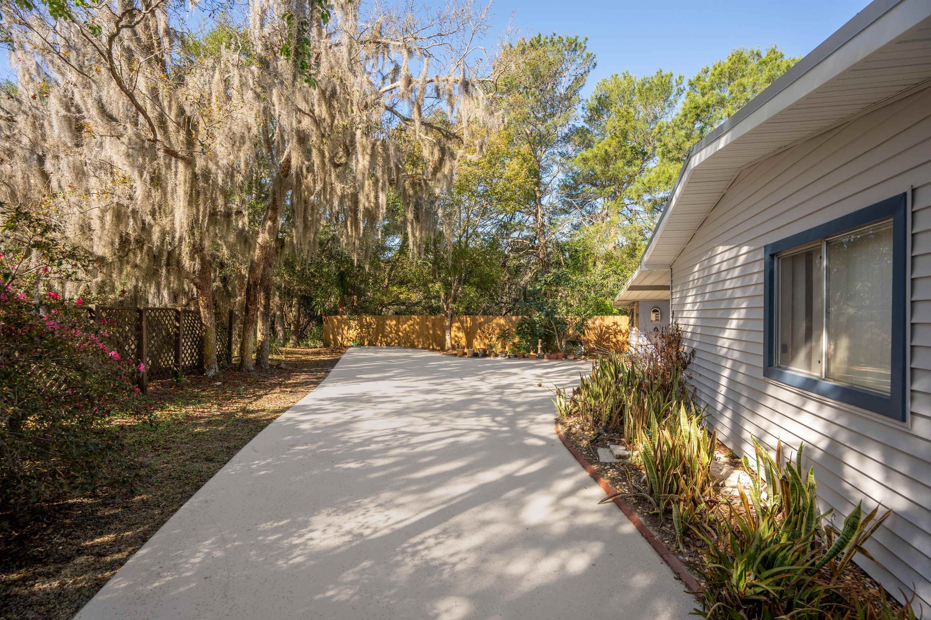 3979 Oak Terrace Road St. Augustine, FL 32086 - Photo 2 of 36 a view of a backyard with plants