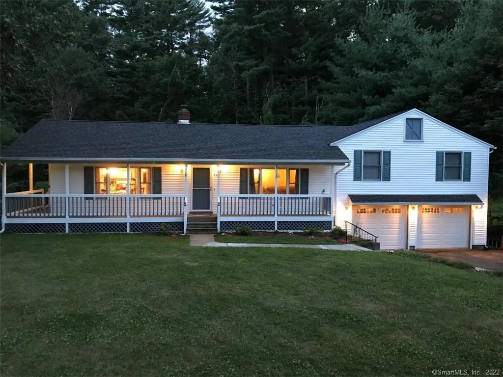 a view of a house with a backyard
