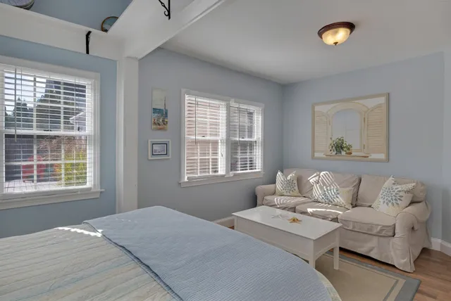 a bedroom with a large bed and a window