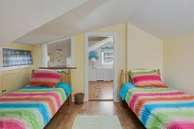a view of hallway with wooden floor and cabinet