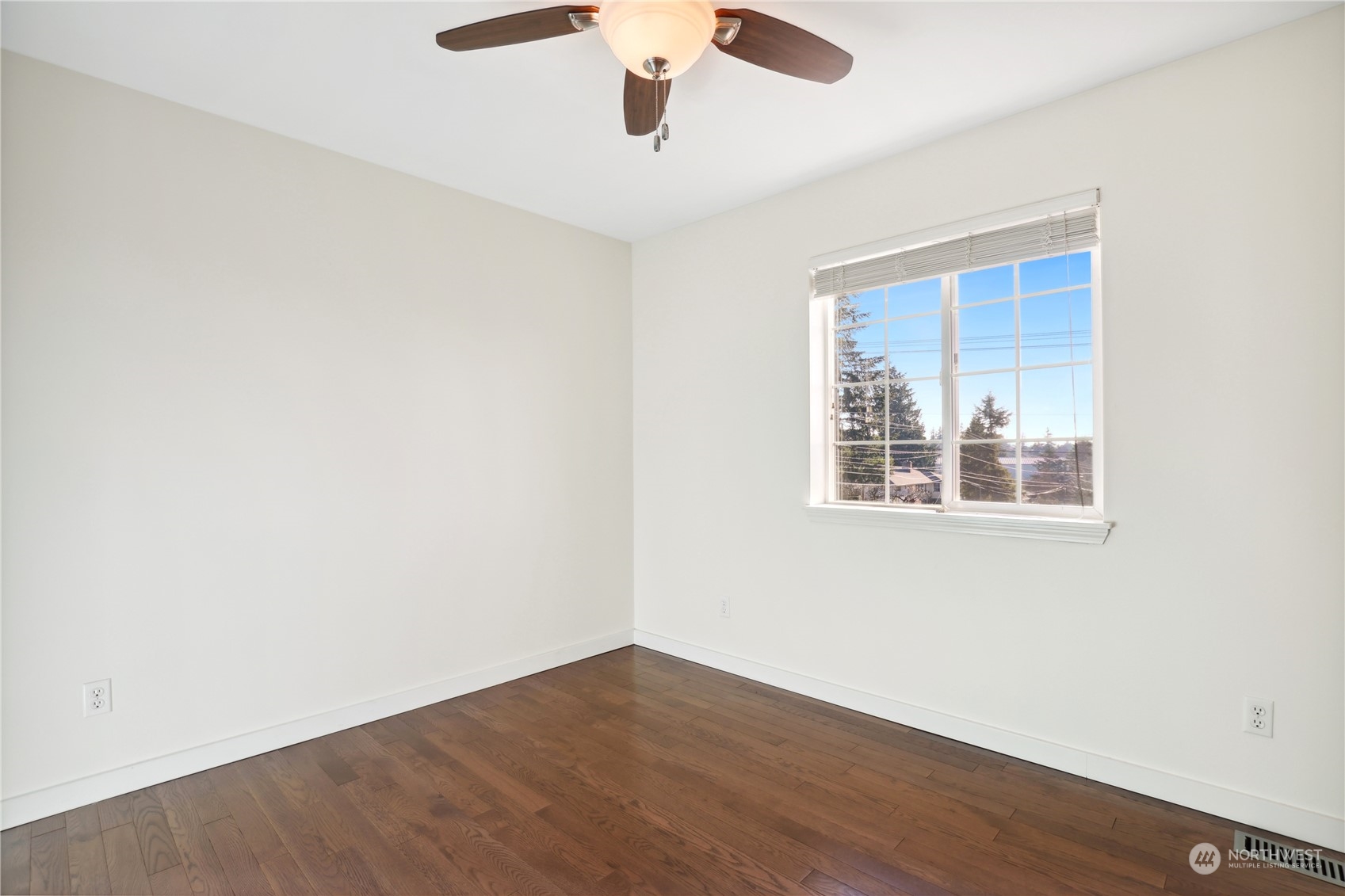 2028 Northeast 12th Street Renton, WA 98056 - Photo 13 of 40 an empty room with wooden floor and windows