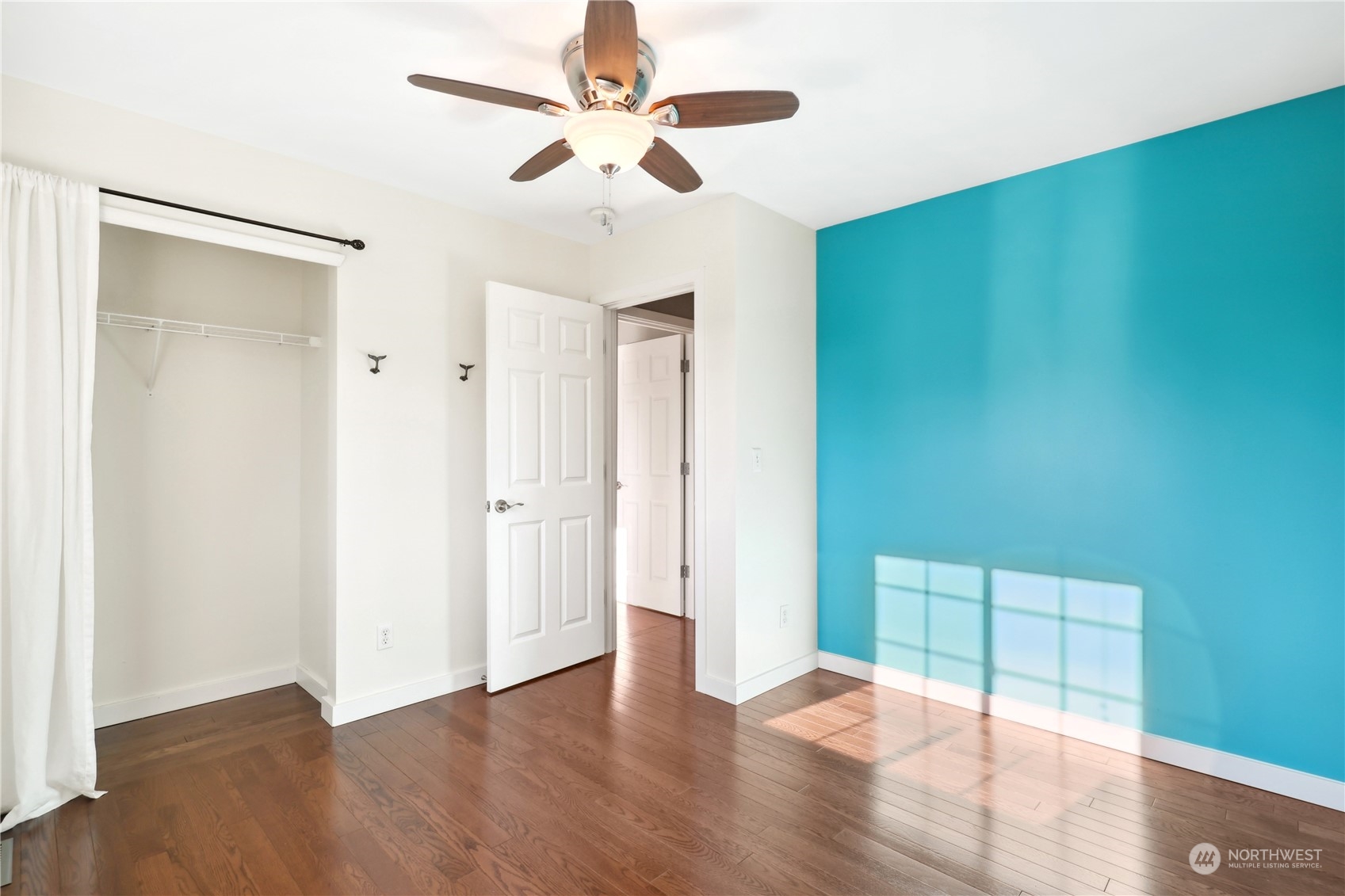 2028 Northeast 12th Street Renton, WA 98056 - Photo 14 of 40 an empty room with wooden floor fan and windows