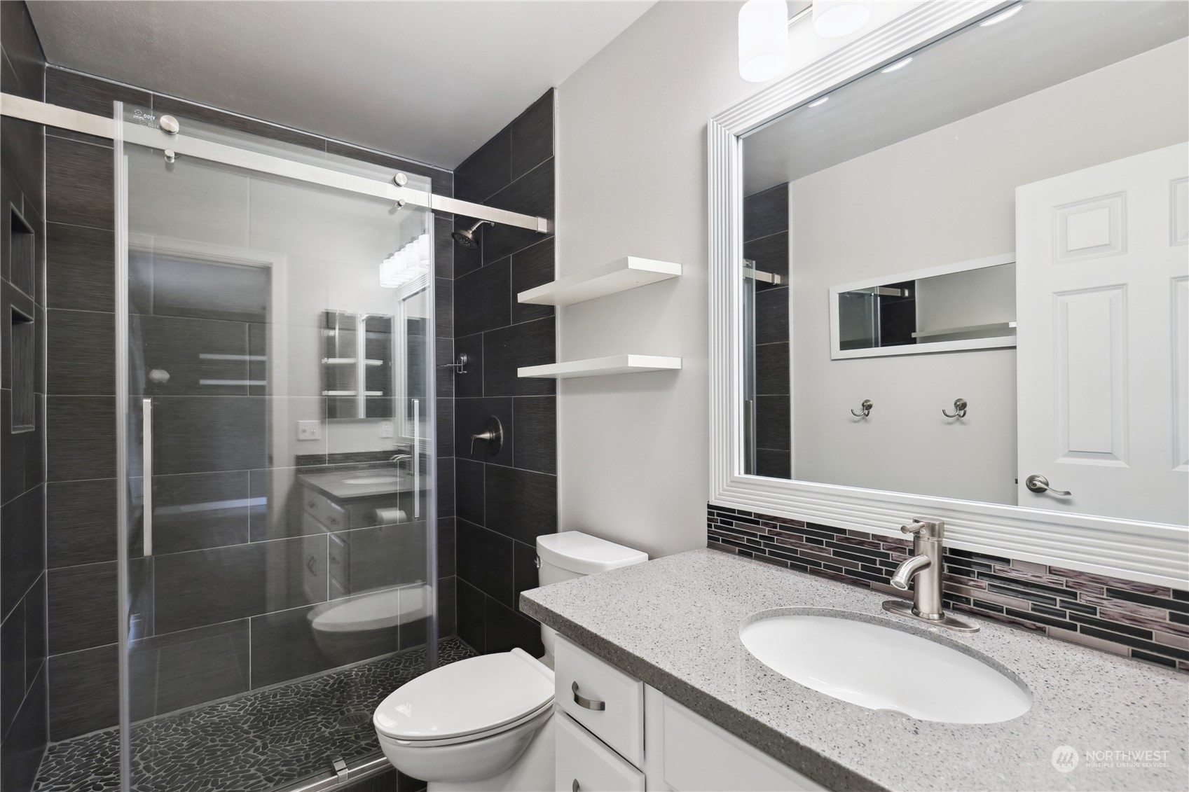 2028 Northeast 12th Street Renton, WA 98056 - Photo 21 of 40 a bathroom with a sink toilet and shower