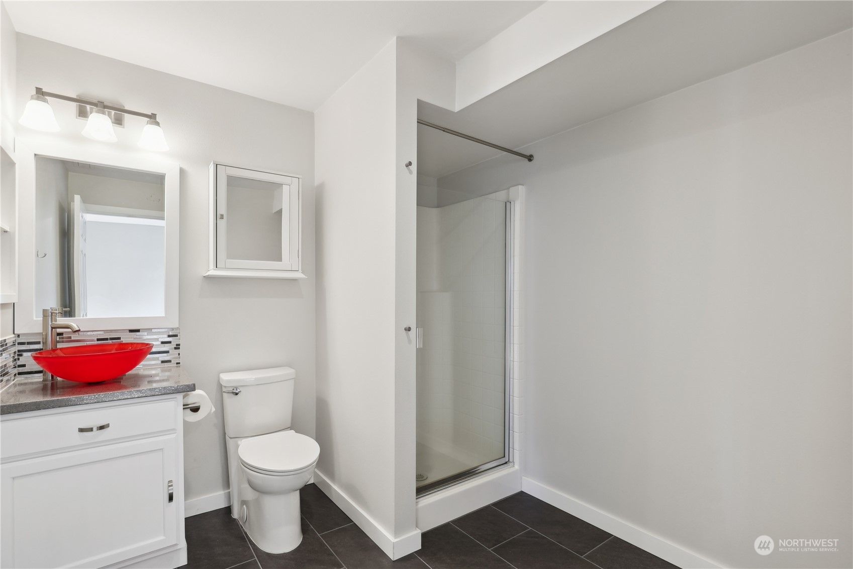 2028 Northeast 12th Street Renton, WA 98056 - Photo 22 of 40 a bathroom with a toilet sink vanity and mirror