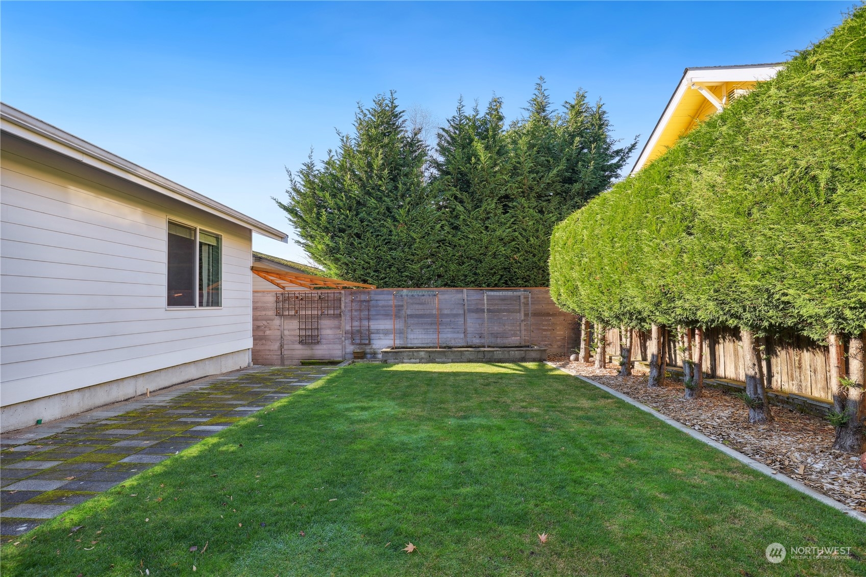 2028 Northeast 12th Street Renton, WA 98056 - Photo 30 of 40 a view of a backyard with a large tree