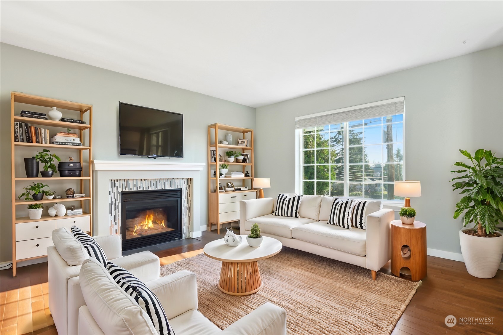 2028 Northeast 12th Street Renton, WA 98056 - Photo 3 of 40 a living room with furniture a flat screen tv and a fireplace