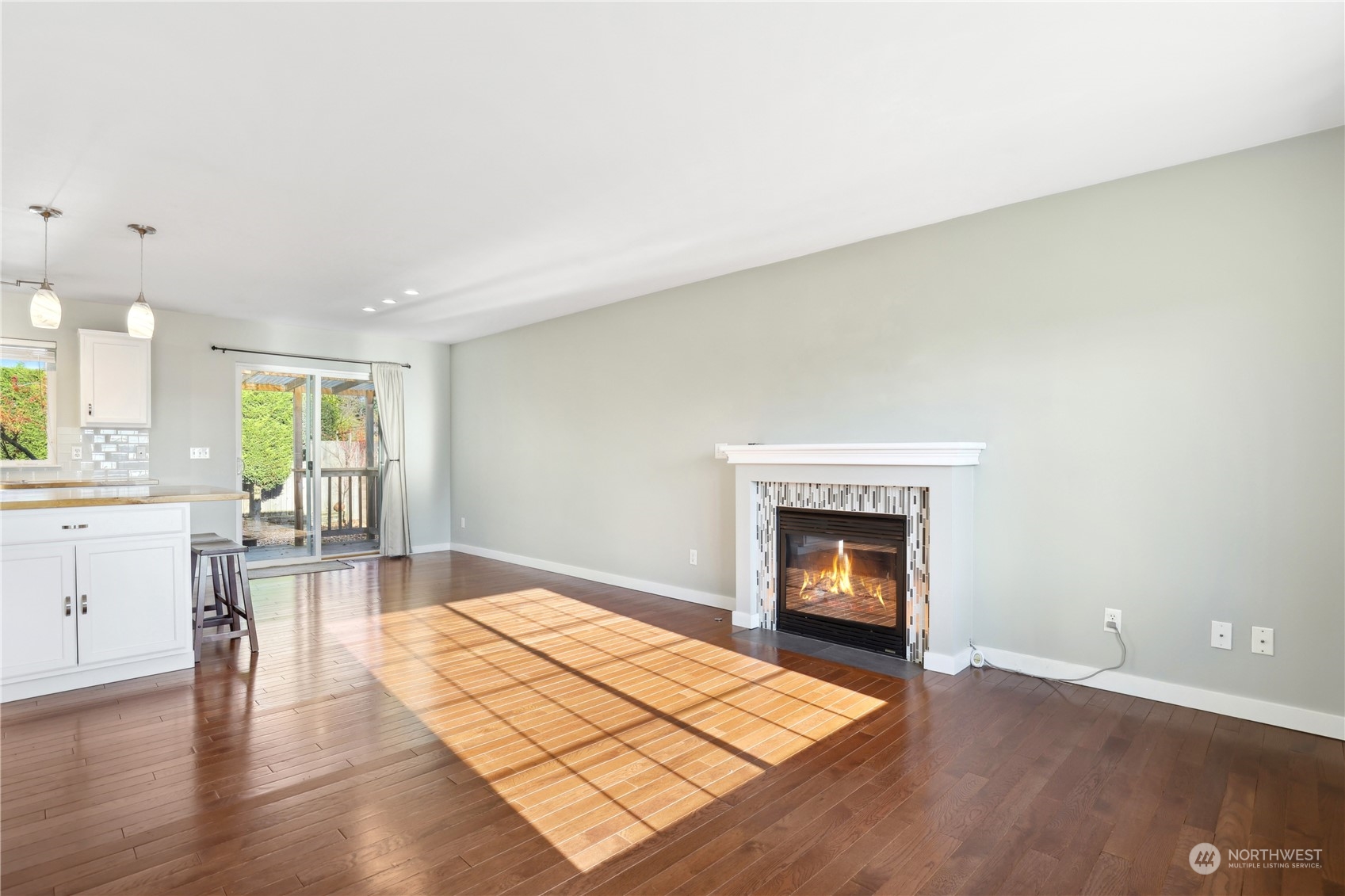 2028 Northeast 12th Street Renton, WA 98056 - Photo 4 of 40 a view of empty room with wooden floor and fireplace