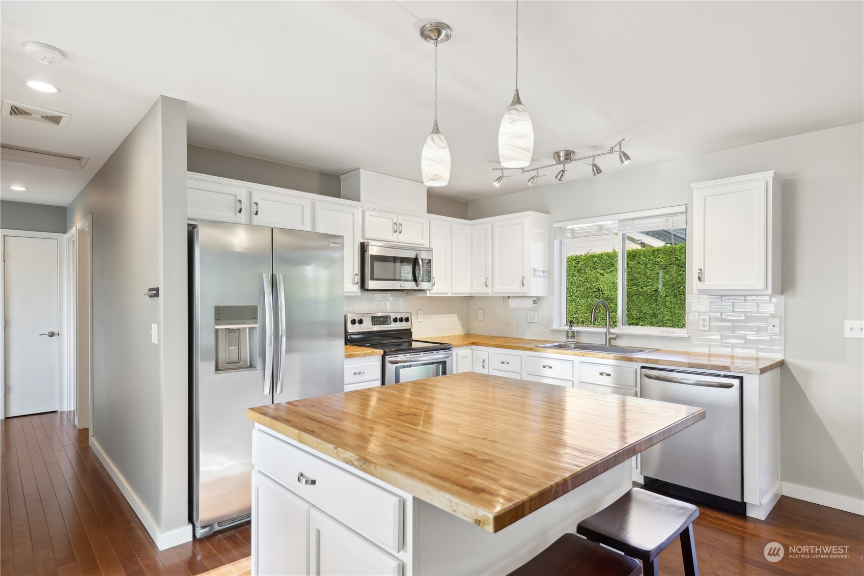 2028 Northeast 12th Street Renton, WA 98056 - Photo 6 of 40 a kitchen with stainless steel appliances granite countertop a sink a stove and a refrigerator