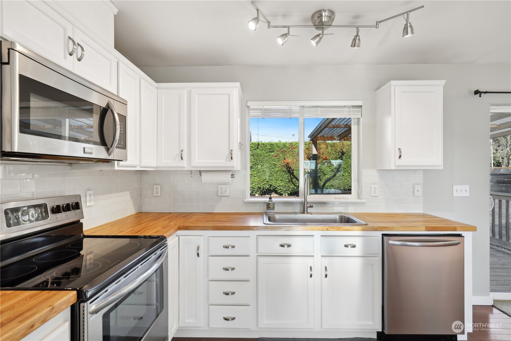 2028 Northeast 12th Street Renton, WA 98056 - Photo 10 of 40 a kitchen with granite countertop white cabinets white stainless steel appliances and a sink