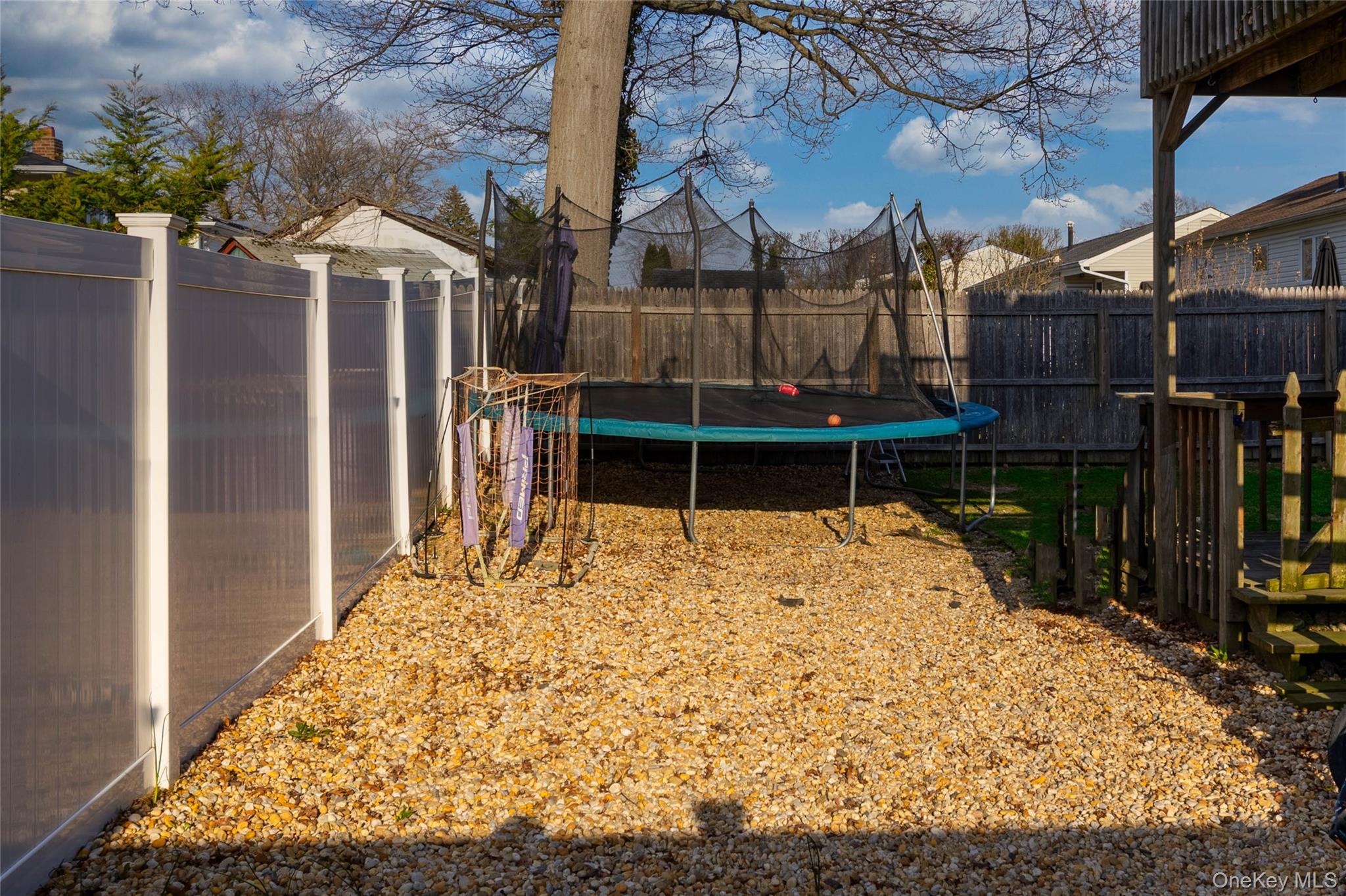 151 Cheltenham Road West Babylon, NY 11704 - Photo 12 of 12 The property features a fenced yard with a gravel area
