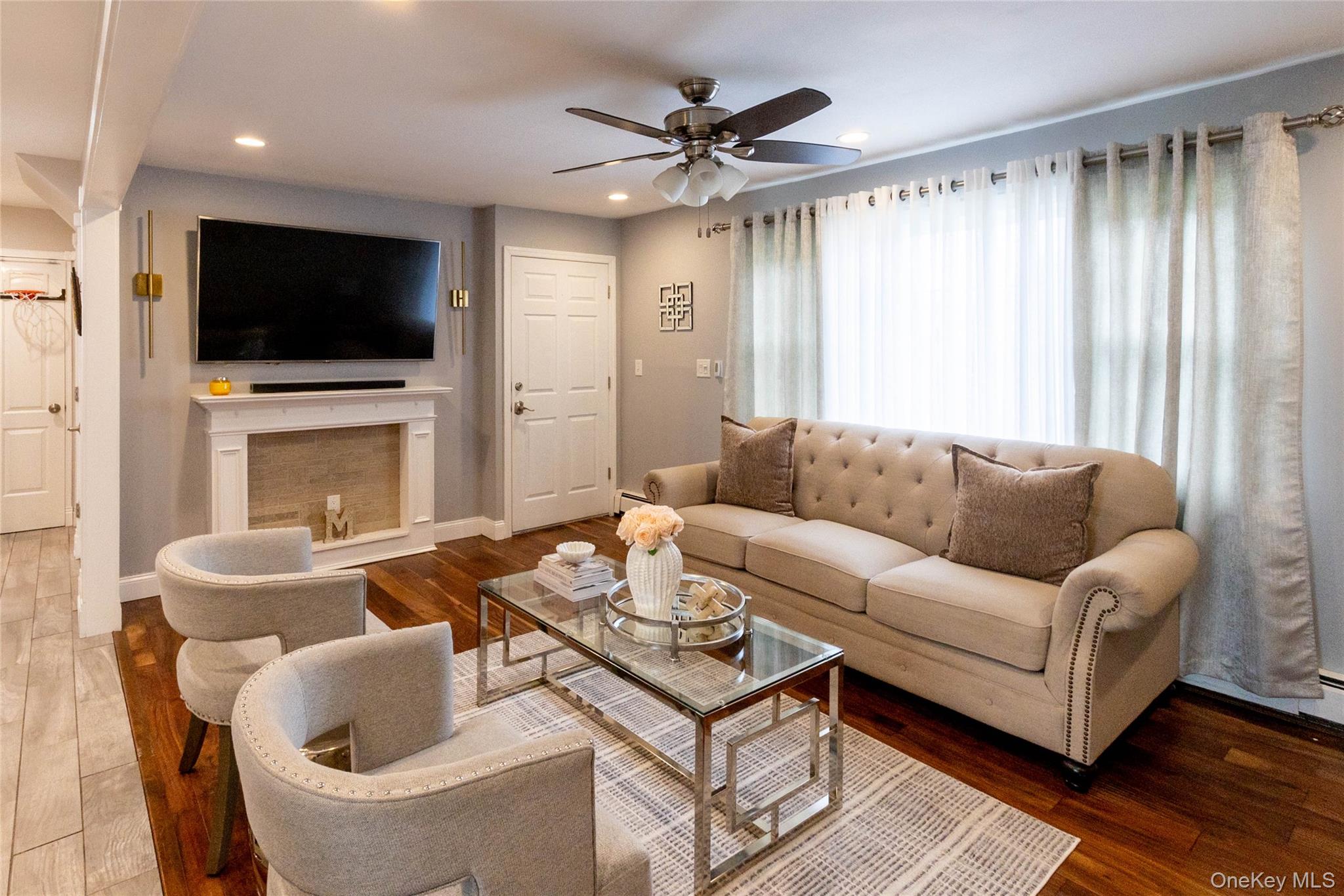 151 Cheltenham Road West Babylon, NY 11704 - Photo 15 of 42 Living area featuring rich wood-finish flooring, recessed lighting, and a ceiling fan