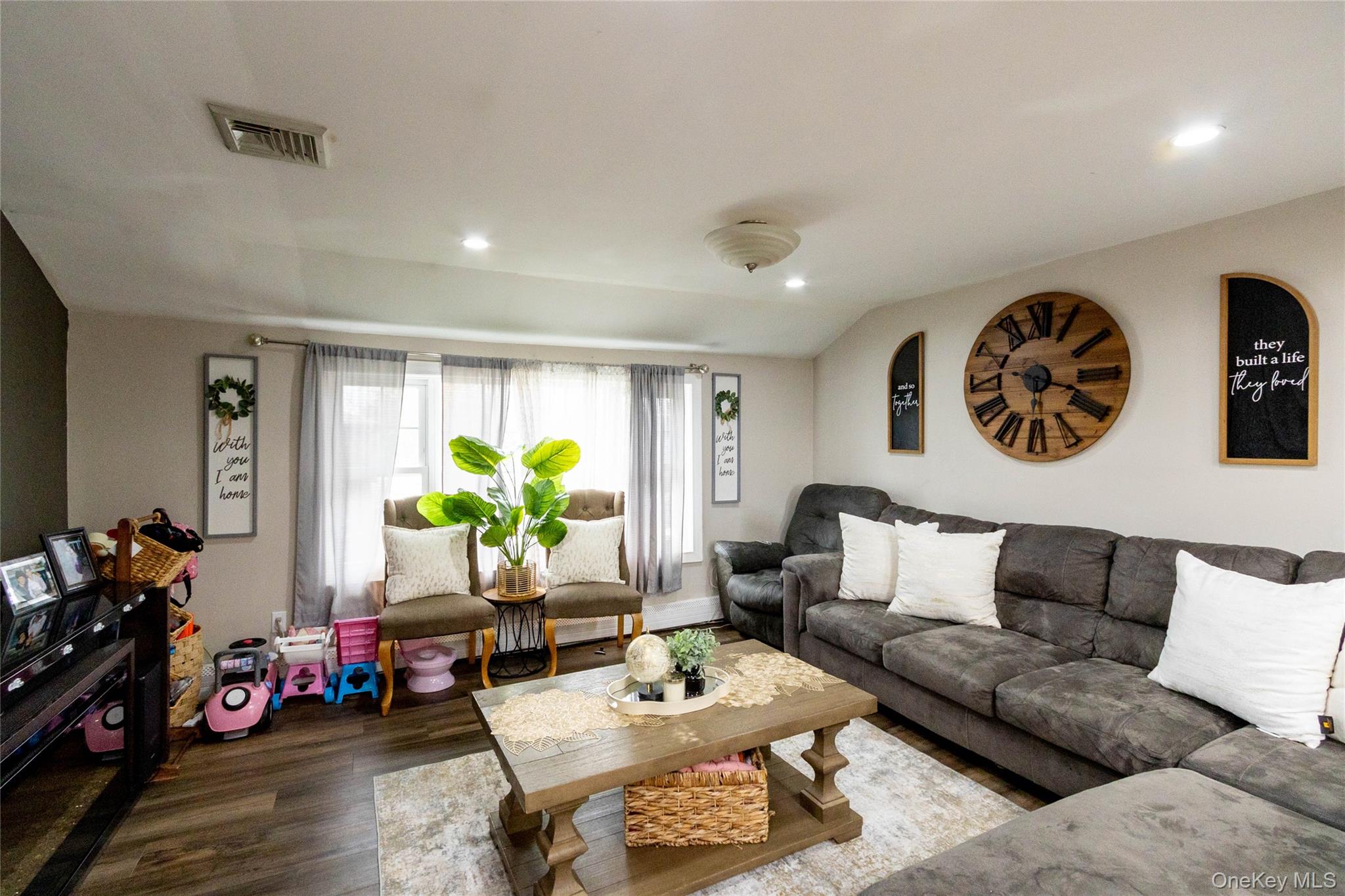 151 Cheltenham Road West Babylon, NY 11704 - Photo 26 of 42 Spacious living area featuring wood-finish flooring, recessed lighting, and ample natural light from multiple windows