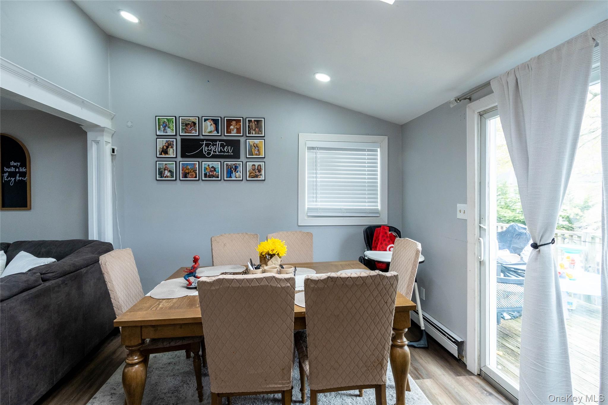 151 Cheltenham Road West Babylon, NY 11704 - Photo 28 of 42 Dining area featuring wood-finish flooring and a vaulted ceiling