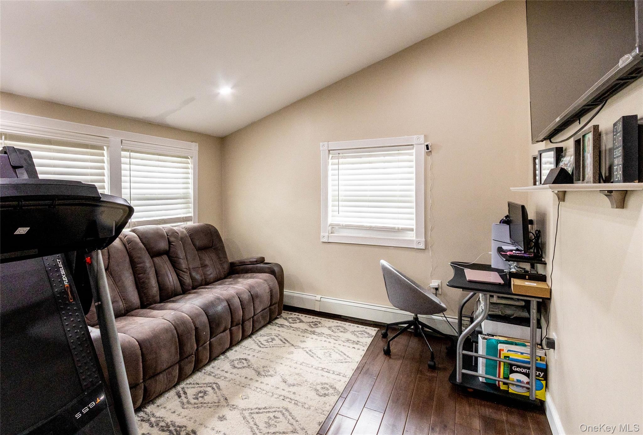 151 Cheltenham Road West Babylon, NY 11704 - Photo 38 of 42 Spacious room featuring wood-finish flooring, an angled ceiling, multiple windows with blinds, and recessed lighting