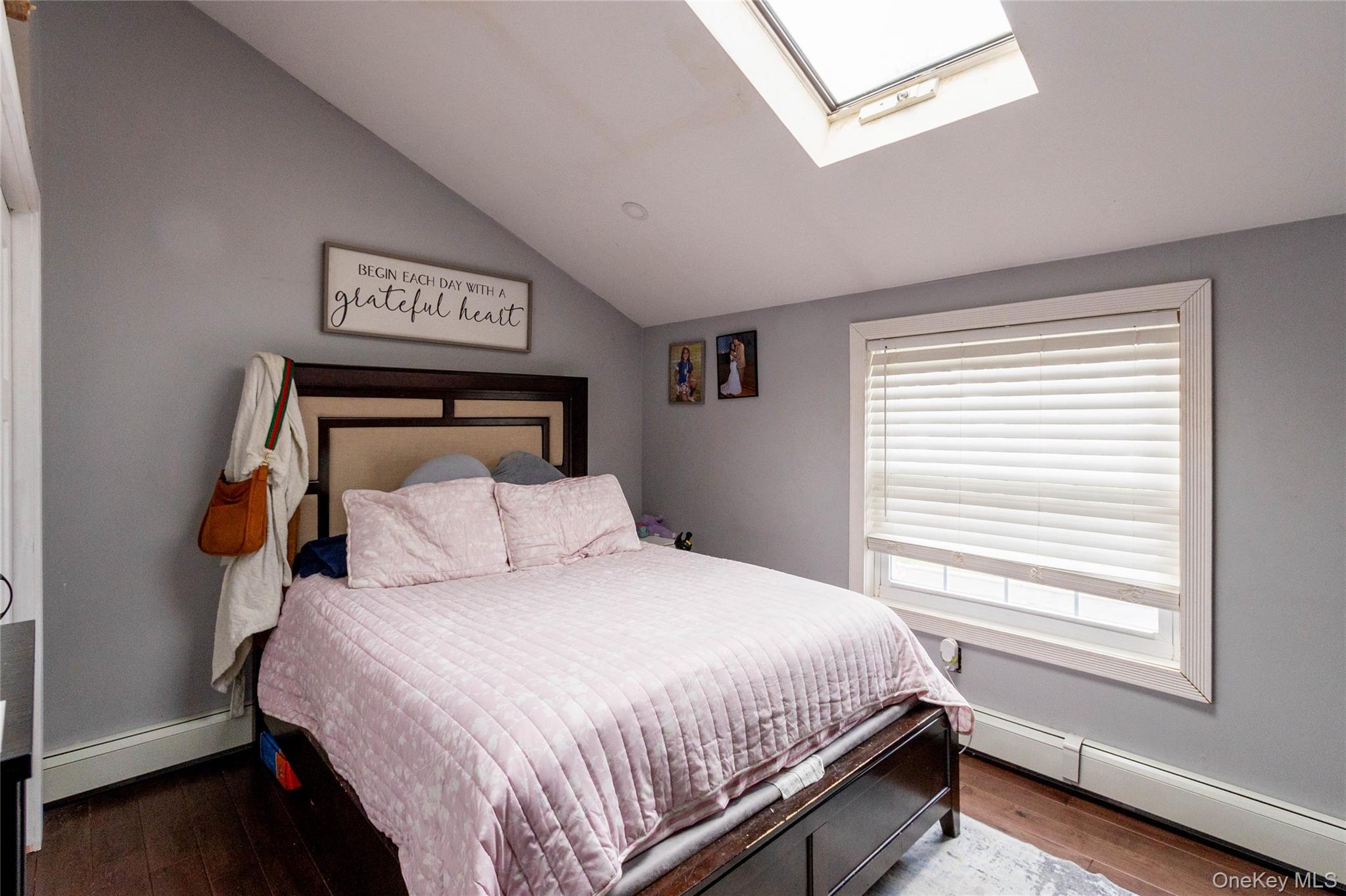 151 Cheltenham Road West Babylon, NY 11704 - Photo 40 of 42 Bedroom featuring a sloped ceiling, wood-finish flooring, and a large window with blinds